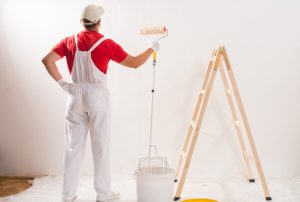 Young Man On Painting Wall With Roller