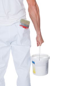 Painter Holding A Paint Roller And Bucket On White Background